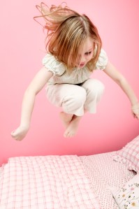Girl Jumping on Bed